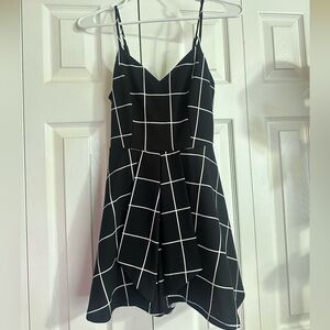 Black and white plaid pattern mini romper dress.